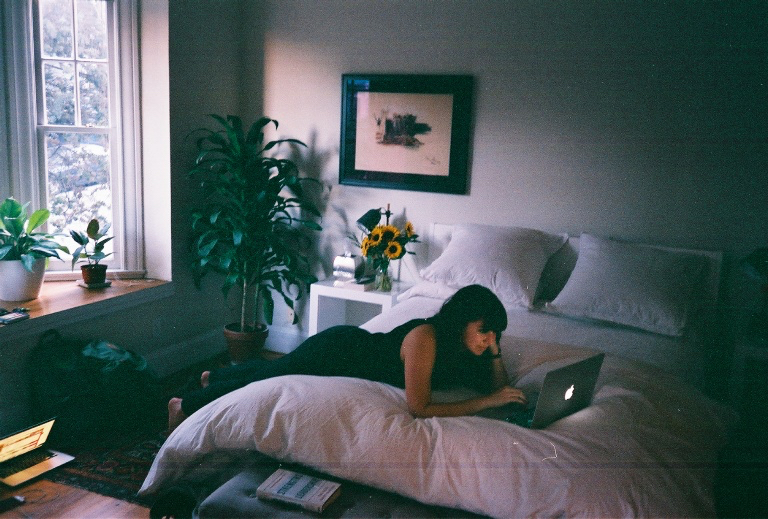 Claire and Brandon in a shop, Brandon taking a mirror selfie on film